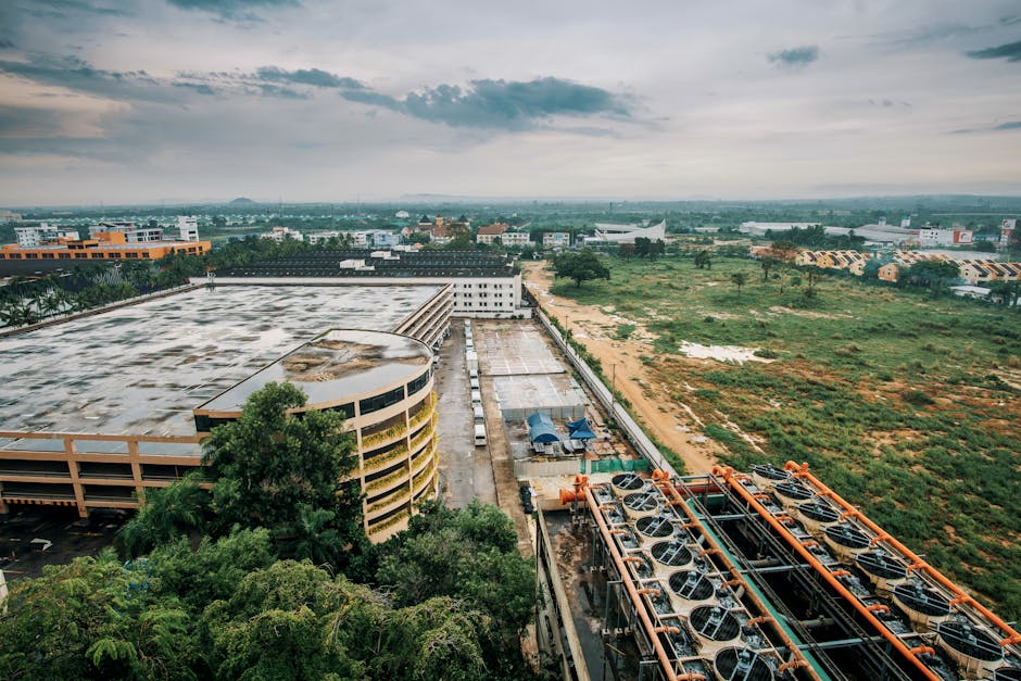 Industrial complex with adjacent greenery, highlighting cityscape and infrastructure.